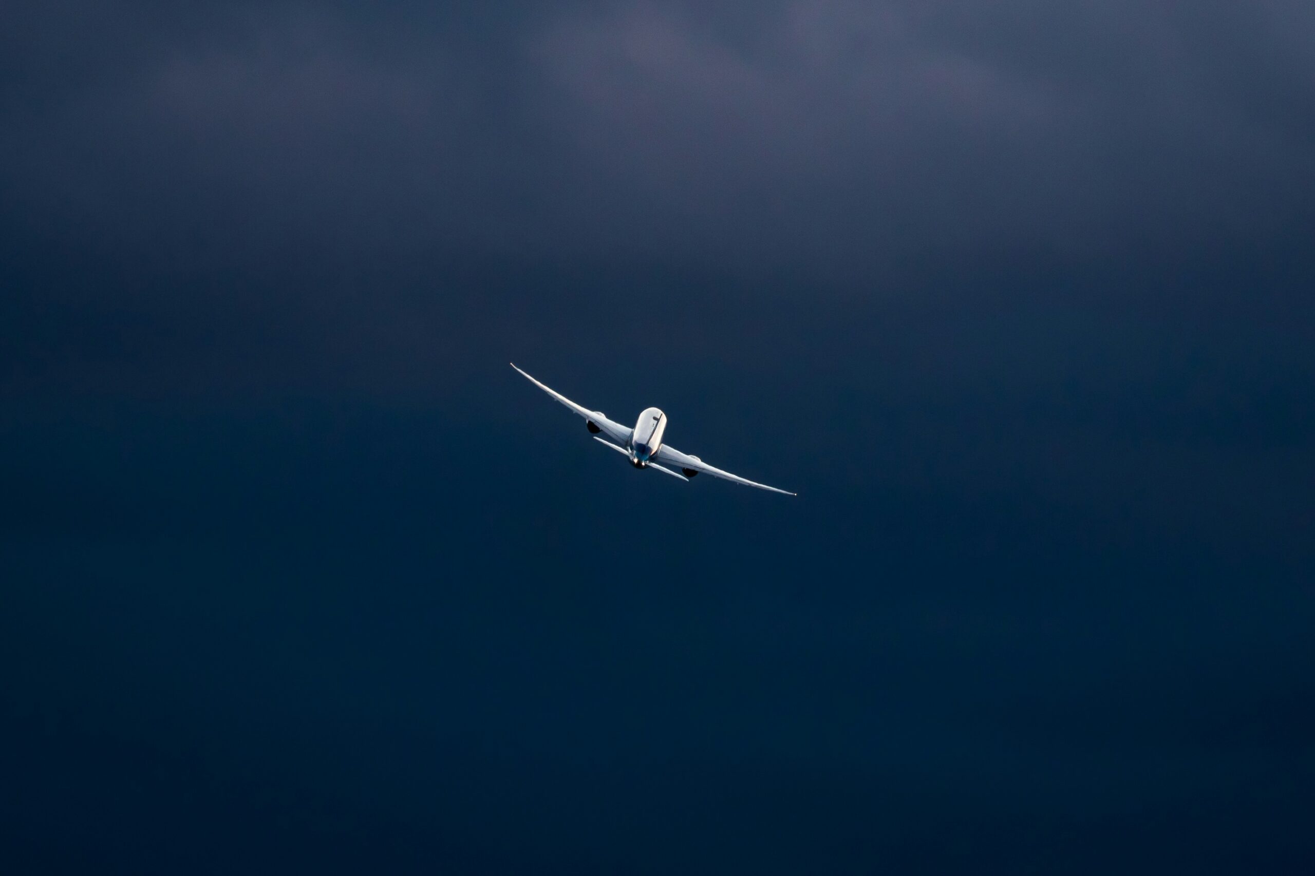 Photo of a plane in a vast sky